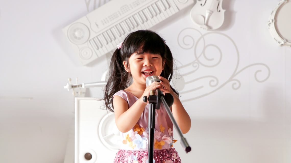 kid singing into microphone