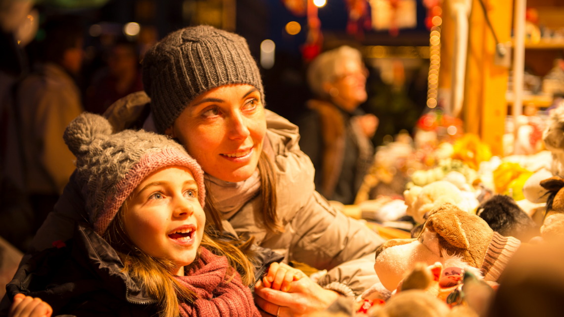 mom and daughter at christmas market